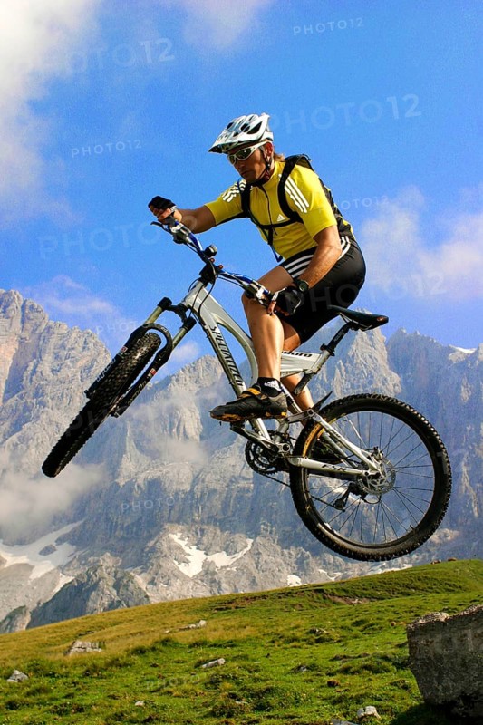 A man on a mountain bike in an alpine landscape