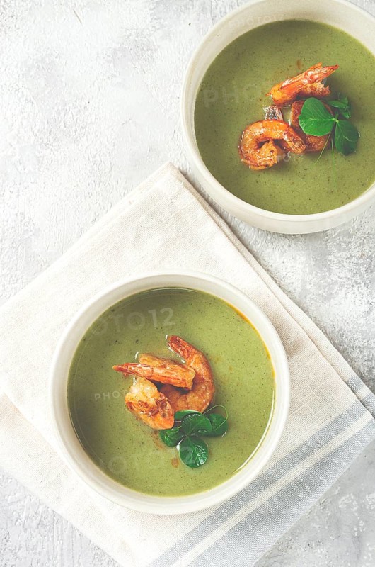 Pea cream soup, with shrimp, green soup, homemade, top view, no people