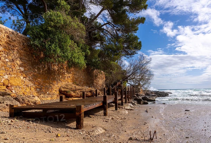 Wooden walkway destroyed by the sea, east coast in Cala Ratjada, Majorca, Spain