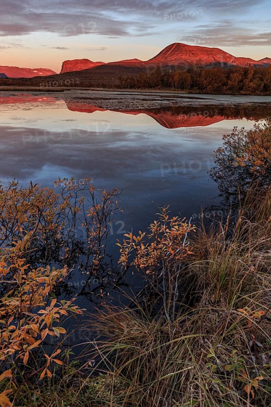 Mountains reflected in lake, autumn colours, cloudy mood, morning light, dawn, Nikkaluokta, Laponia, Lapland, Sweden