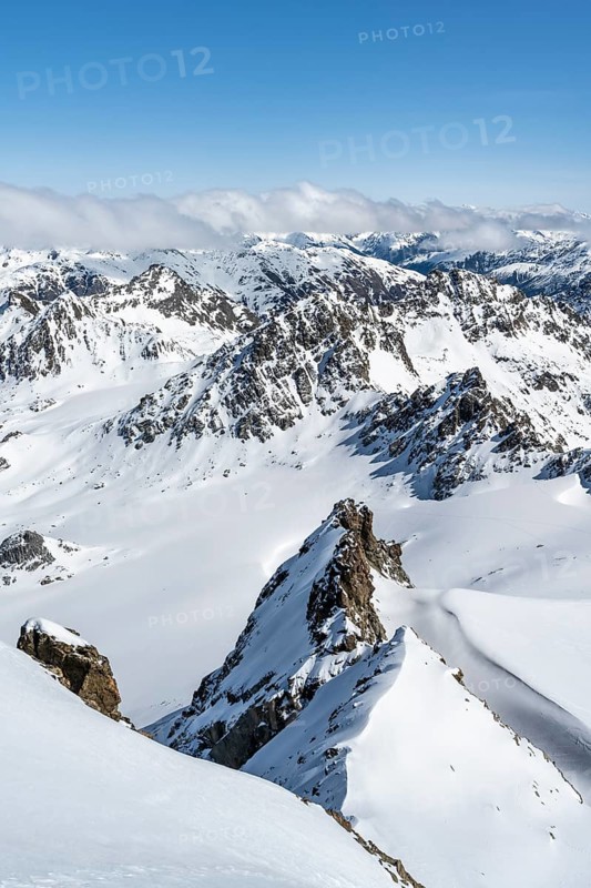 Mountain ridge of Piz Kesch, ascent on Piz Kesch or Piz d'Es-cha in winter, spectacular mountain landscape, view of mountain panorama with glacier Vadret da Porchabella, Albula Alps, Rhaetian Alps, Grisons, Eastern Switzerland, Switzerland