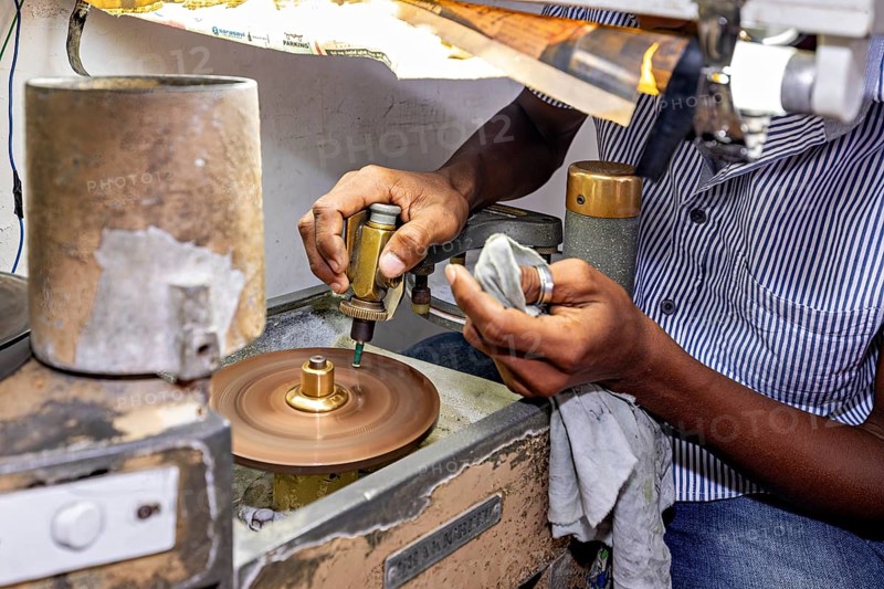 Close-up of hands working on a grinding machine with precision tools, the gemstone cutters in the city of Ratnapura in Sri Lanka