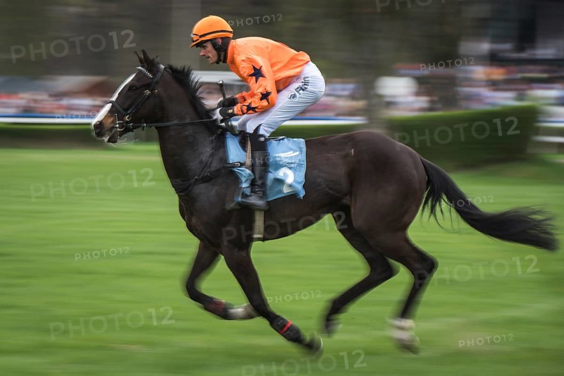 WROCLAW, POLAND - APRIL 15, 2018: International race with obstacles for four years horses at Racecourse WTWK Partynice. The opening day of the season. In action jockey J. Bartos on the horse Idol