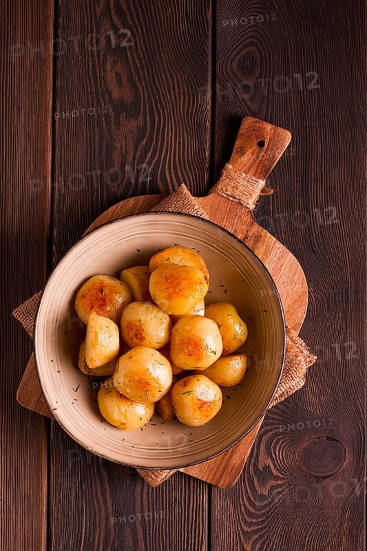 Fresh Cooked, new potatoes, with dill, on a wooden table, selective focus. close-up, toning, no people