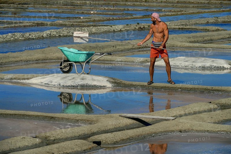 France, Brittany, A man extracting salt in Salants de Guerande