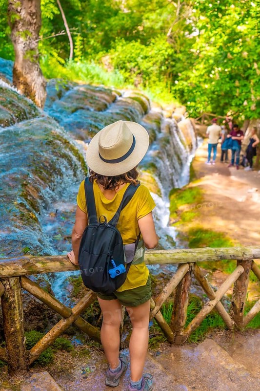 A female tourist walking among waterfalls in the Monasterio de Piedra Natural Park, Aragon