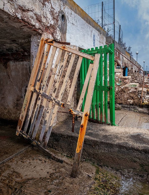 Old and dilapidated boat shelters that are not being used, old port area in Portocolom on the east coast of Majorca, Spain