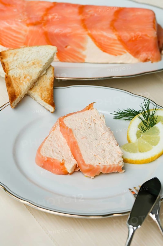 Southern German cuisine, salmon trout terrine arranged on a plate, salmon terrine with trout fillets, fish dish, salmon fillets, smoked salmon, starter, fine dining, Sunday crockery with gold rim, grandma's service, lemons, dill, fish cutlery, toast, food photography, studio, Germany