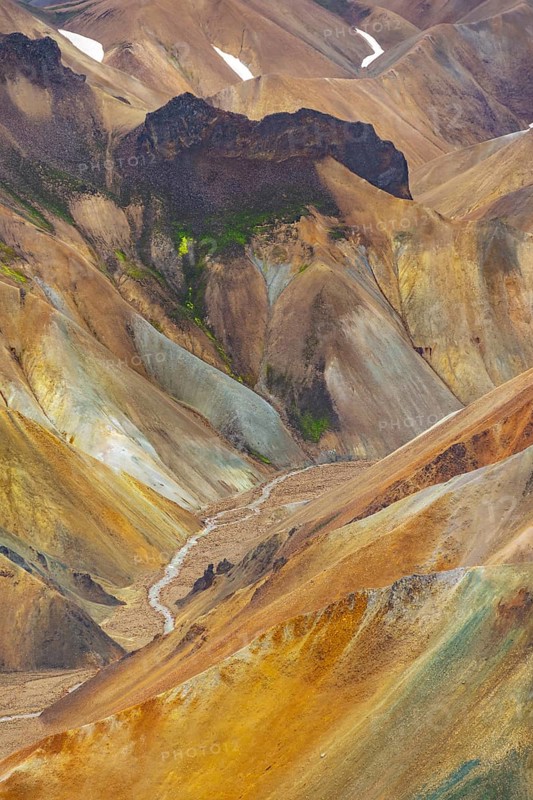 Small river between colourful rhyolite mountains, volcanic landscape, erosion landscape, view from Brennisteinsalda Landmannalaugar, Fjallabak Nature Reserve, Icelandic Highlands, Suðurland, Iceland