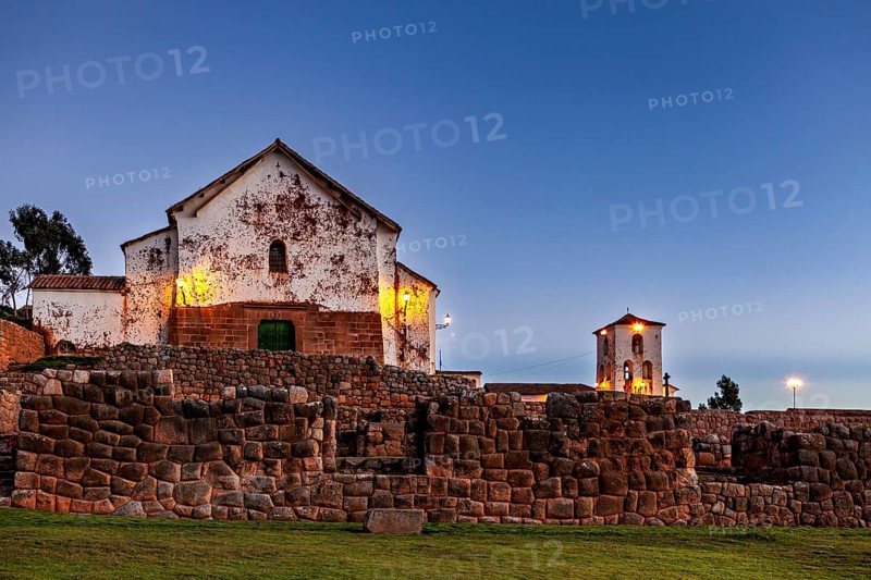 Illuminated church with stone walls in the blue hour, quiet evening mood, the historic village of Chinchero in the Sacred Valley of the Incas in Peru