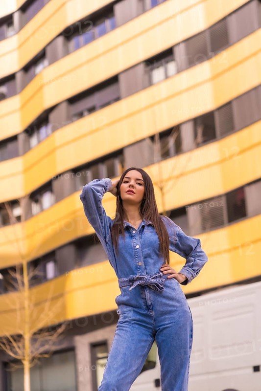 Young caucasian girl with a monkey cowboy in a yellow and black house. Enjoying the city on vacation, lifestyle of a young girl, in a trendy posing