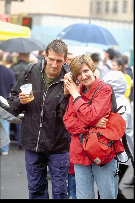 Young couple talking on the phone on the street, New York, USA