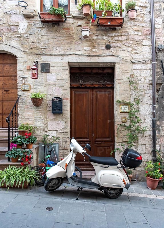 Vespa scooter in the streets of Assisi Old Town, Umbria, Italy
