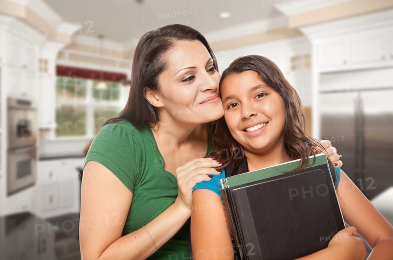 Proud Hispanic Mother and Daughter In Kitchen at Home Ready for School