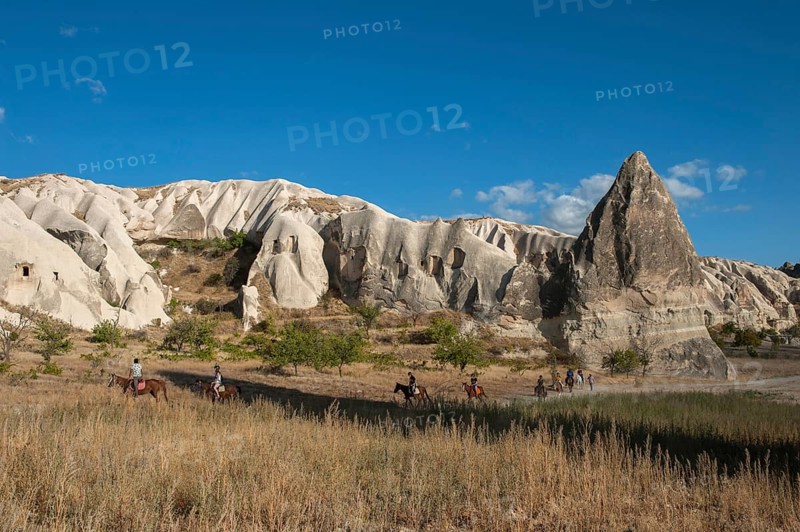 Cappadocia, Turkey. September 19th 2018 A group of tourists taking a horse trekking tour through amazing landscape near the Red Valley, the rock formations of Cappadocia, Turkey