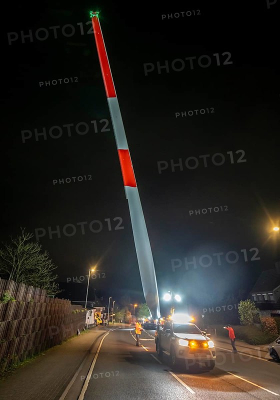 Transport of a 68 metre long, 22 tonne blade of a wind turbine, here in Schwelm, with a self-propelled Blade-Lifter vehicle, over a 40 km long route, over 2 nights, in the Bergisches Land, through towns, villages, over country roads, narrow through roads, to the construction site of the wind turbine near Hagen, North Rhine-Westphalia, Germany
