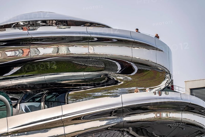 The Fenix Museum of Contemporary Art about migration, in a former warehouse on the Nieuwe Maas, walk-in spiral staircase made of polished stainless steel, in the shape of a double helix, called tornado, 550 meters long from ground floor to a viewing platform on the roof, with a view of the Rotterdam skyline, architect Ma Yansong, the Netherlands