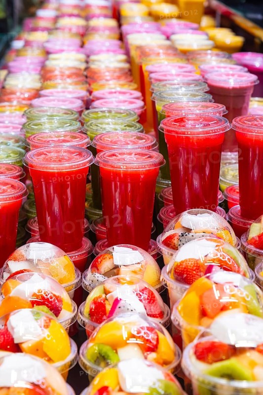 Smoothies and plastic fruit containers at La Boqueria market in Barcelona, Spain