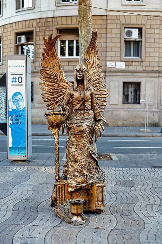 Street performer, mime, living statue of a golden angel, fantasy figure with wings, city centre, Barcelona, Spain