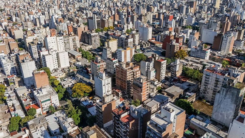 From above, this image captures the dense architectural landscape of Rosario city, Argentina, illustrating a multitude of residential and commercial buildings. The cityscape is densely packed with high-rises