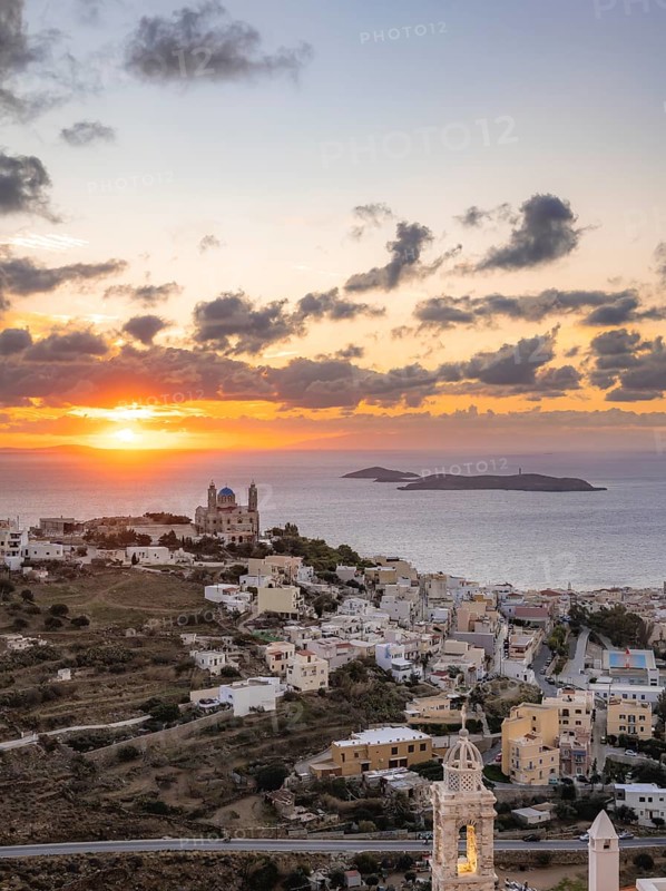 View from Ano Syros to the houses of Ermoupoli with the Anastasi Church or Church of the Resurrection, town view with islands and sea, dramatic cloudy sky at sunrise, Ano Syros, Syros, Cyclades, Greece