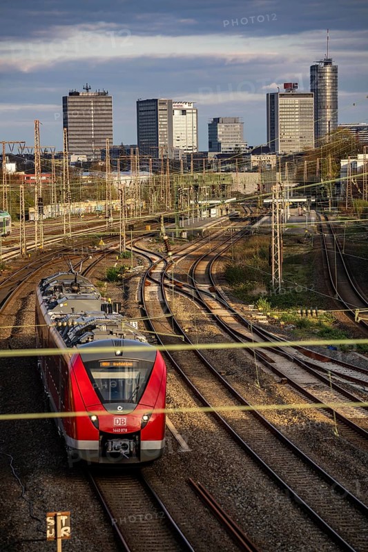 Train on the tracks west of Essen central station, city centre skyline, regional express train, North Rhine-Westphalia, Germany