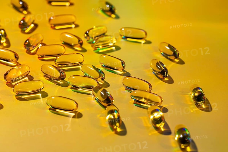 A vivid display of softgel capsules showcases their potential as a health supplement rich in essential vitamins, highlighting their role in supporting daily wellness routines