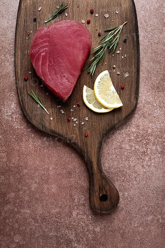 Fresh red tuna fillet, for steak, raw, top view, on a cutting board, no people