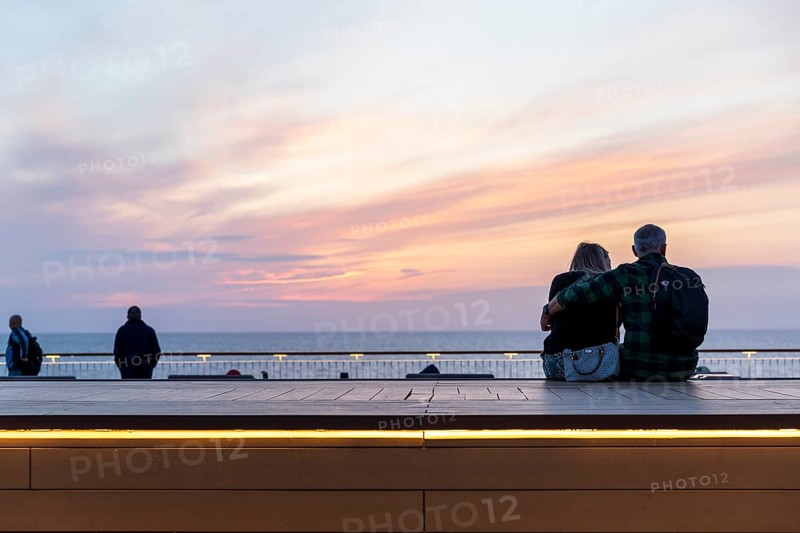 Couple watching sunset on ferry crossing from Rostock in Germany to Trelleborg in Sweden