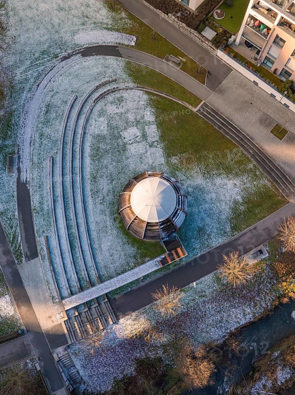 Circular pavilion on a snow-covered lawn in the municipal park, Nagold, Black Forest, Germany