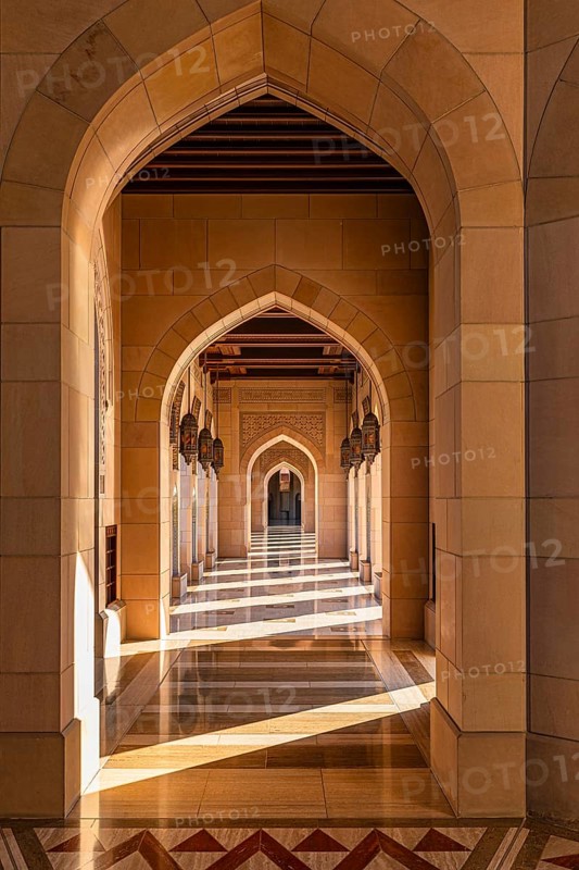 Sunlit arcade of the Sultan Qaboos Mosque, Muscat, Arabian Peninsula, Sultanate of Oman