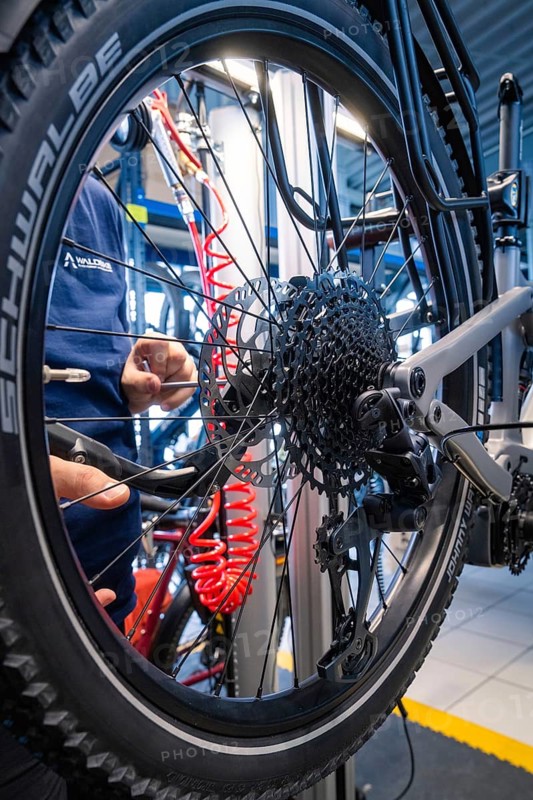 Close-up of a bicycle wheel with Schwalbe tyres in a workshop during maintenance, Waldbike Manufaktur, bicycle workshop, Calw, district of Calw, Black Forest, Germany