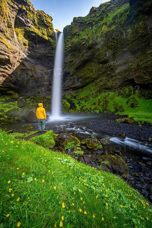 Tourist at Kvernufoss waterfall, in summer when the weather is nice, gorge and river, long exposure, Skogar, Sudurland, South Iceland, Iceland