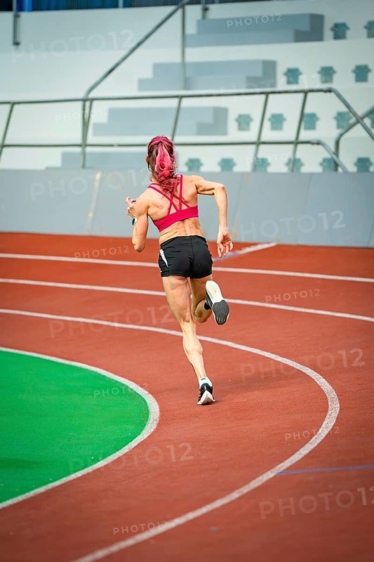 Athlete sets off on a sprint, with focus and speed in a modern stadium, Glaspalast, Sindelfingen