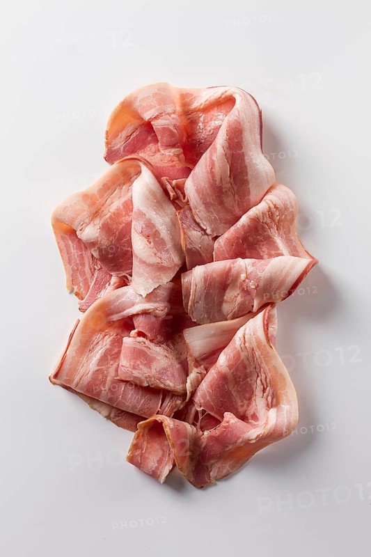 Raw bacon, sliced, on a white background, close-up