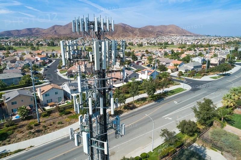 Close-up Aerial of Cellular Wireless Mobile Data Tower with Neighborhood Surrounding