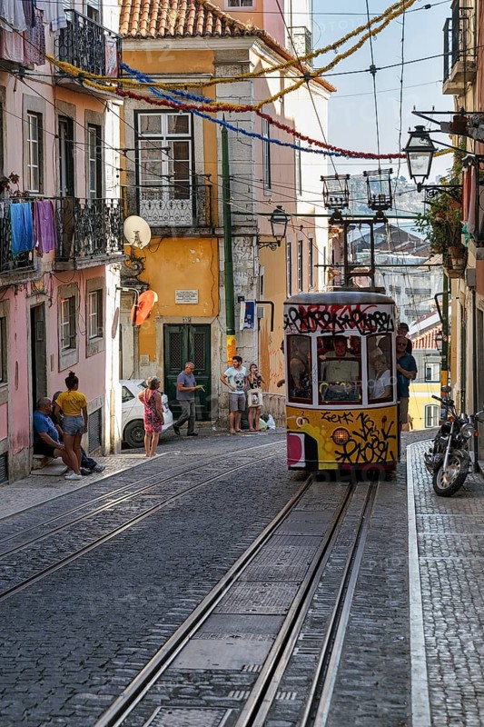 Funicular railway, yellow tram, Elevador da Bica, national monument, old residential buildings, pedestrians in narrow streets, Bairro Alto, Lisbon, Portugal