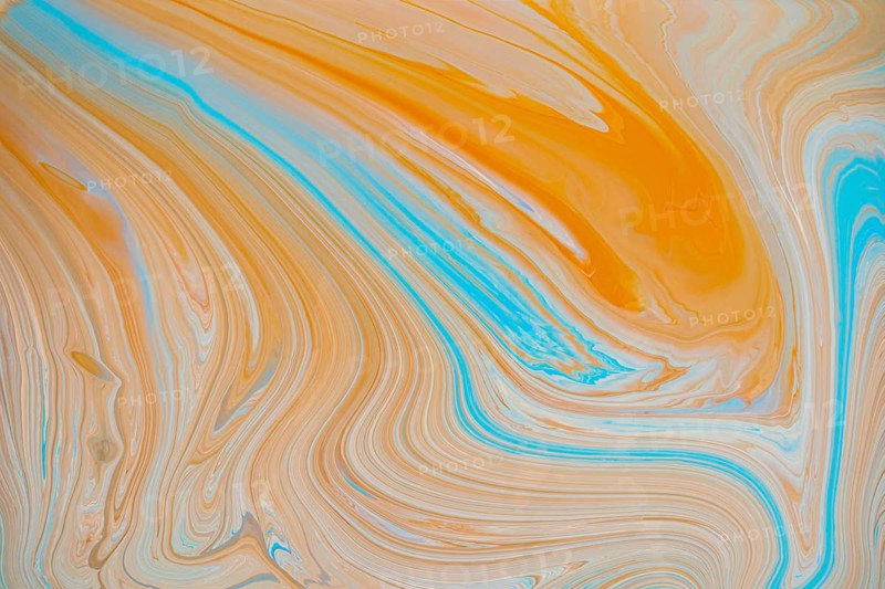 A vibrant abstract image showcasing flowing swirls of orange and teal acrylic paint hues. The fluid movement and blending of colors create a dynamic, artistic background