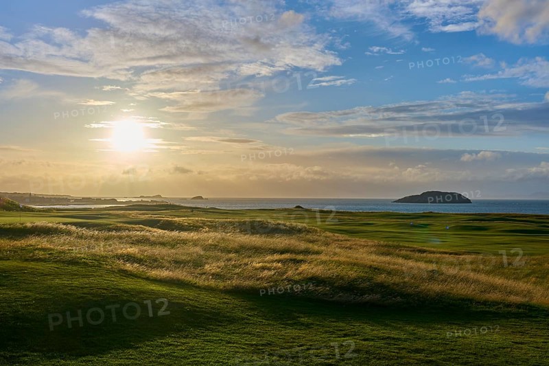 Green field in warm sunset with view of ocean and island, golf course, North Berwick, East Lothian, Scotland, United Kingdom, Great Britain