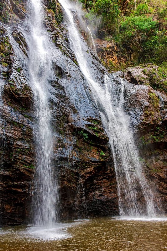 Waterfall within the forest with rocks covered in moss in Minas Gerais, Minas Gerais, Brazil