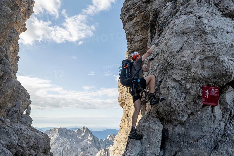 Mountaineer climbs at the start of the Via Ferrata Bocciere Centrale via Ferrata Bocciere Centrale at Bocca degli Armi, Brenta Mountains, Parco Naturale Brenta-Adamello, Trentino, Italy