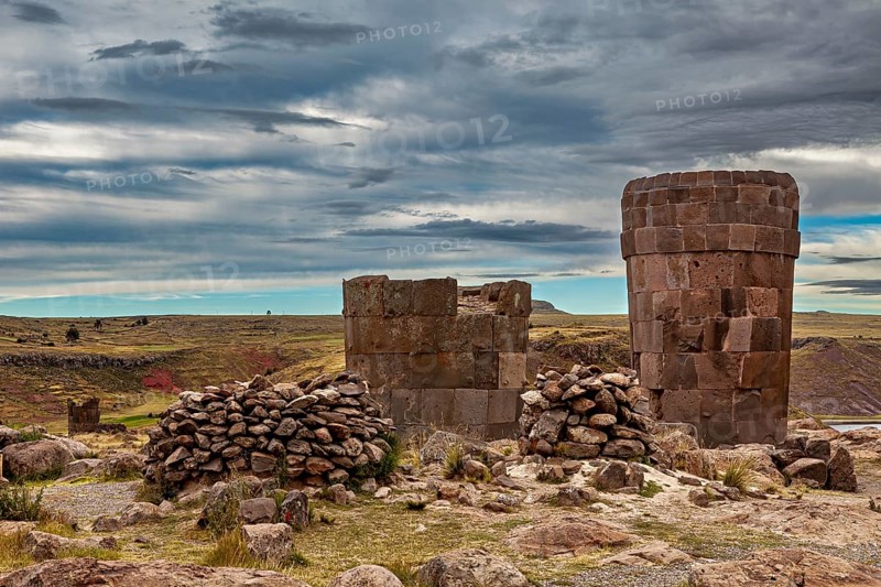 Old stone towers against a dramatic, cloudy sky, The Chullpas of Sillustani near Puno in Peru