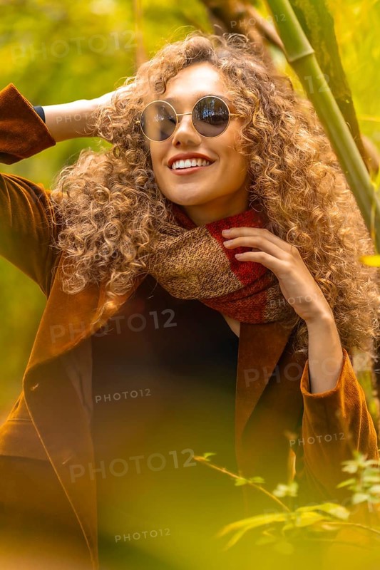 Close-up vertical portrait of a sensual woman in a park during autumn