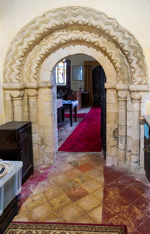 Chevron zig-zag pattern of Norman arched doorway inside church of Saint Peter, Theberton, Suffolk, England, UK
