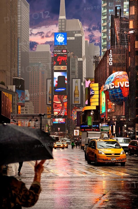 Evening Times Sqaure with illuminated advertising in the rain, New York City, USA