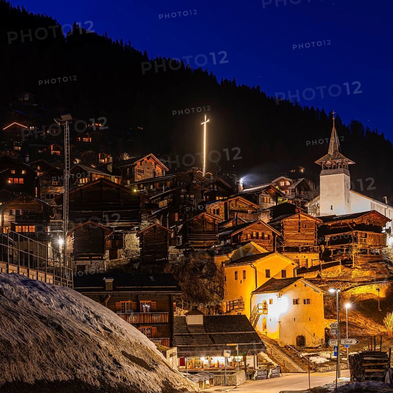 Old farmhouses and barn barn, white cellars, the illuminated cross and the illuminated church tower of the Saint Theodule church, night view, historic town center, Grimentz, Val d'Anniviers, Valais Alps, Canton of Valais, Switzerland