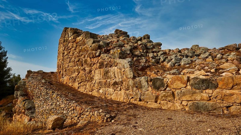 Cyclopean wall, ancient stone ruins with winding path and blue sky in the background, Tiryns, ancient city in Argolis, Mycenaean, Peloponnese, Greece