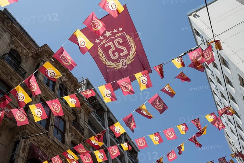 Istanbul, Turkey. June 23rd 2025. Galatasary S.K football and basketball club flags and pennants flying over Istiklal Street near Galatasary Square on the European Side of Istanbul, Turkey