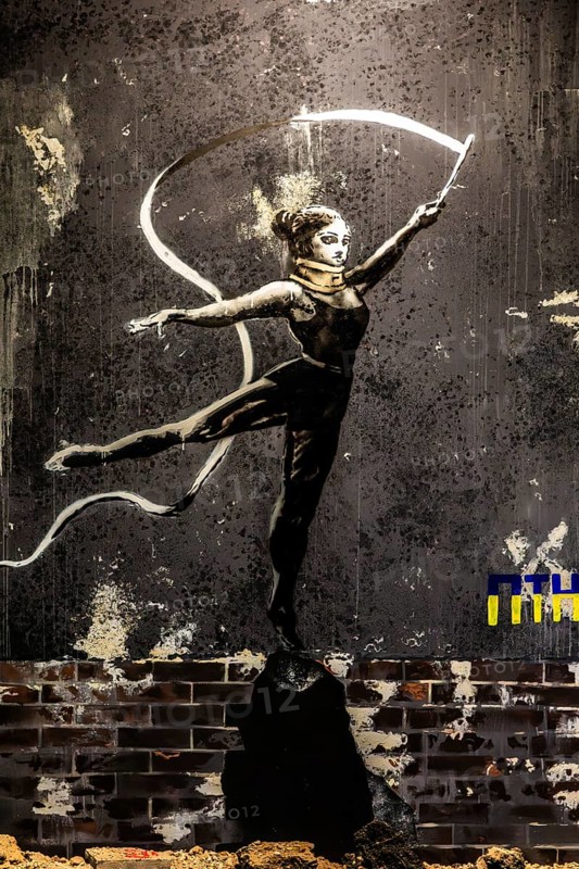 Banksy - Dancer on rubble, painting on a destroyed house wall in the Ukraine, exhibition The World of Banksy