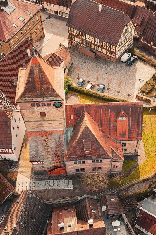 Historic church and surrounding half-timbered houses in an urban old town area, Ötisheim, Enzkreis, Germany